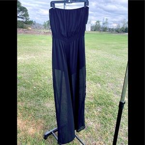 Woman’s strapless sheer jumpsuit has a short she’ll underneath, elastic waist.